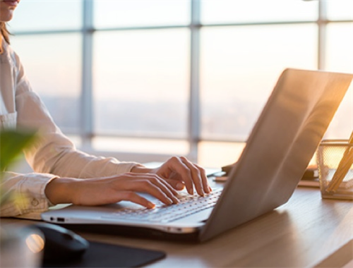 person typing on laptop